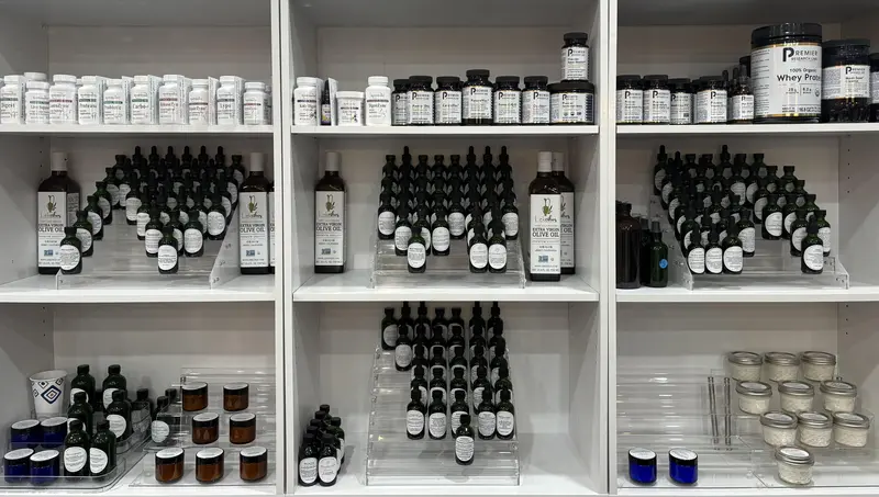 Shelves of tinctures, herbal oils, salves, and supplements — the apothecary cabinet, stocked.